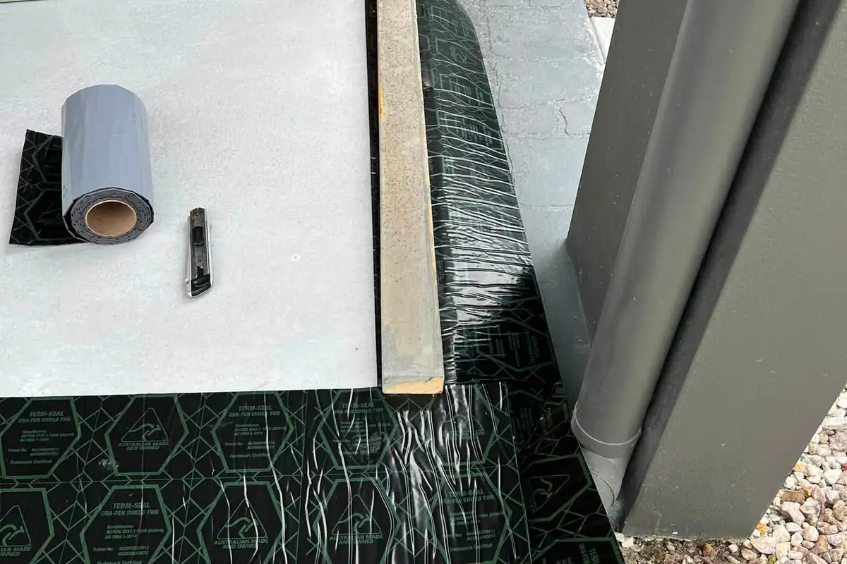 Term-Seal physical termite barrier membrane being installed at a doorway