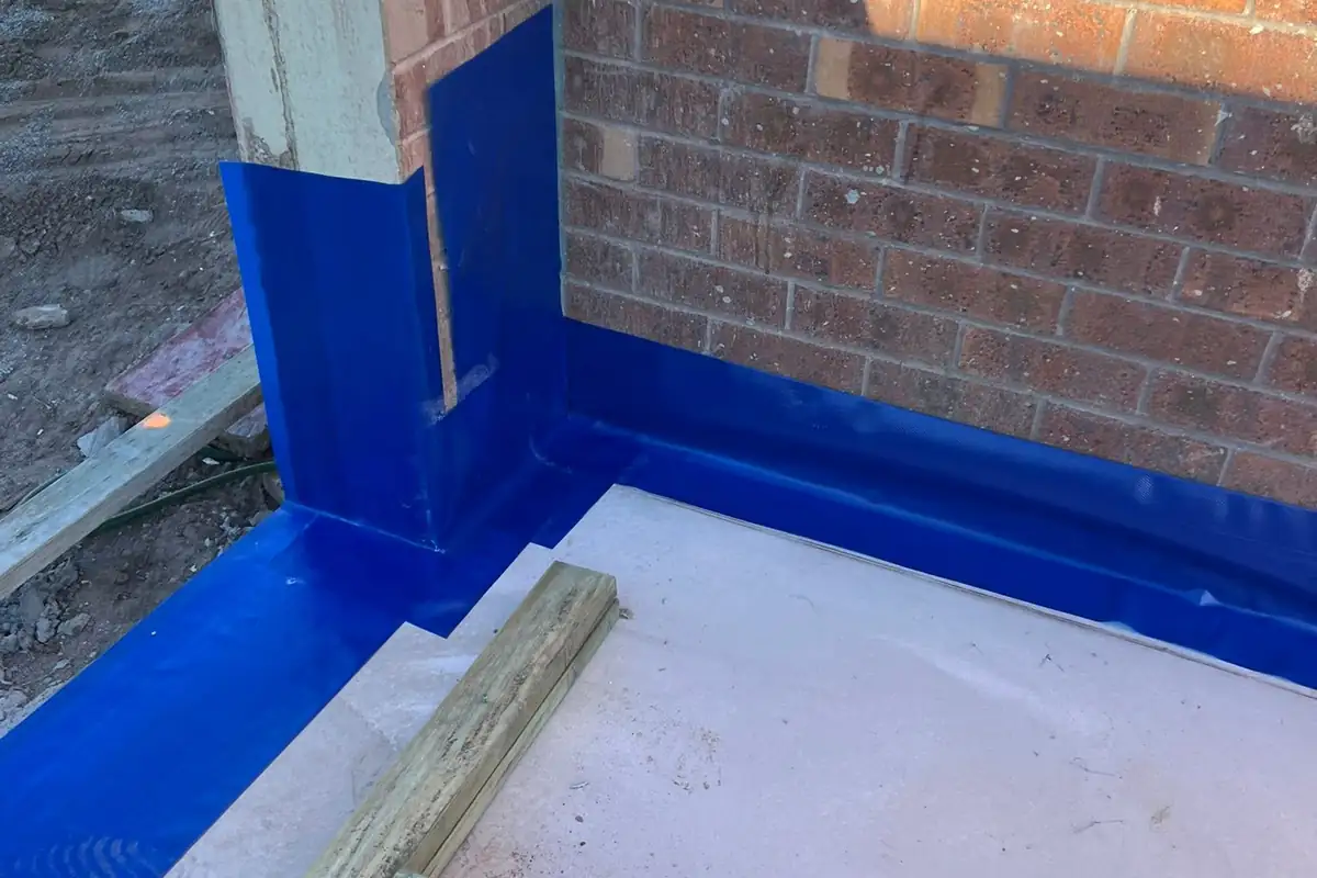 Termite membrane sealed where a new slab meets an existing brick wall